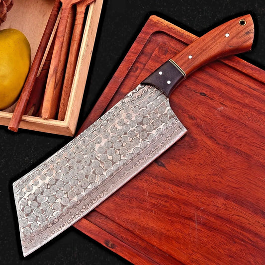7.5 inch hand forged Damascus meat cleaver with rain drop pattern and rosewood handle on cutting board